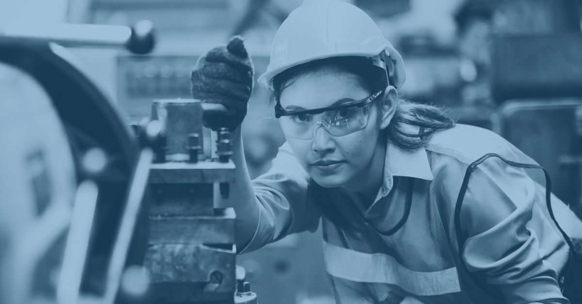 How-to-move-your-manufacturing-ERP-to-the-cloud-factory-worker-lever A female manufacturing worker pulling a lever in a factory symbolizing how easy it is to move manufacturing ERP into the cloud.