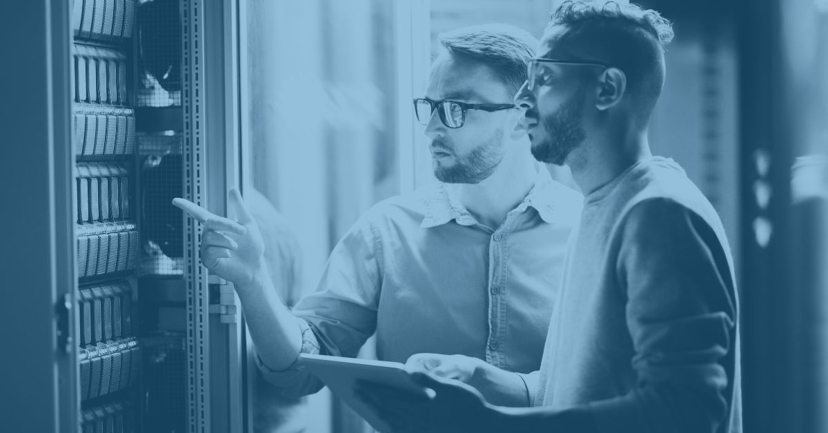 Data center server room with IT engineers addressing tech stack fragmentation concerns for distribution and manufacturing industries.