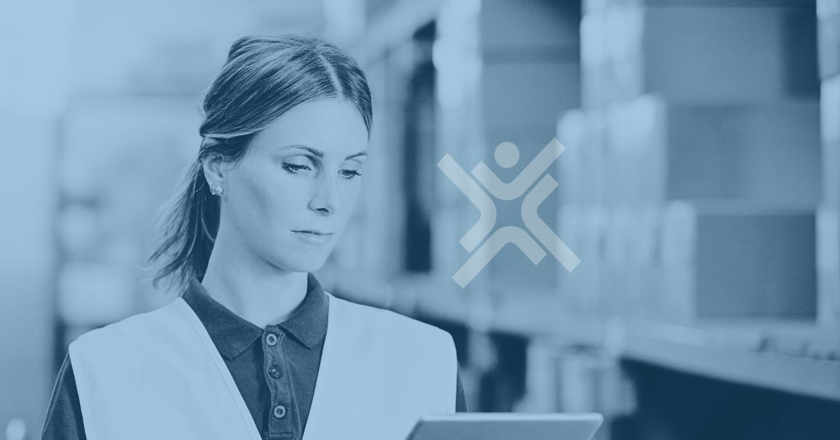 Supply chain manager reviewing ERP inventory data on a mobile device<br />
